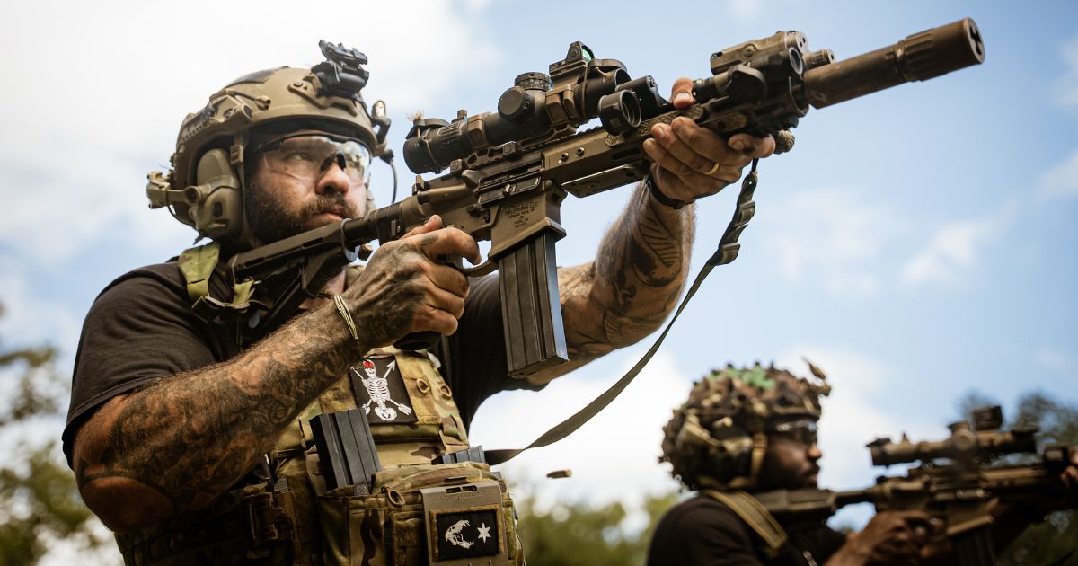 A man shooting his purpose driven rifle outfitted with various One Hundred Concepts rifle gear and accessories.
