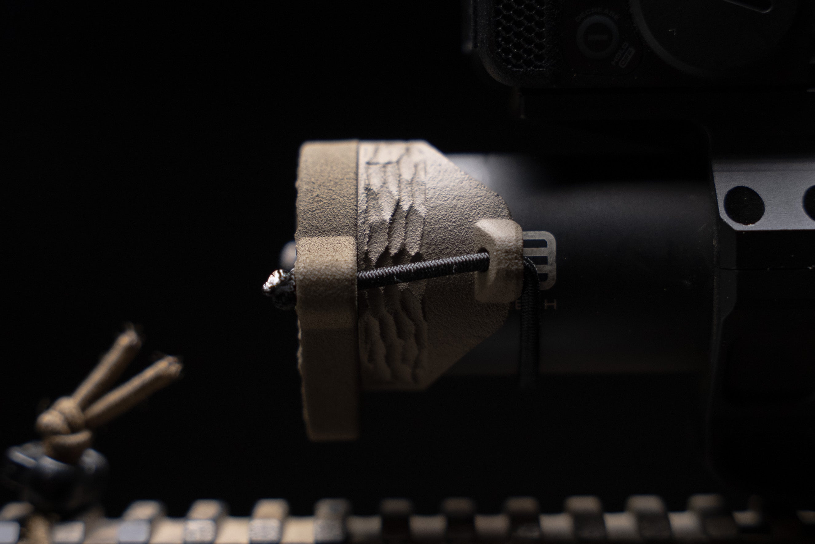 ScopeCap Pro 34mm LPVO scope cover with killflash anti-reflection device attached by shock cord in flat dark earth color