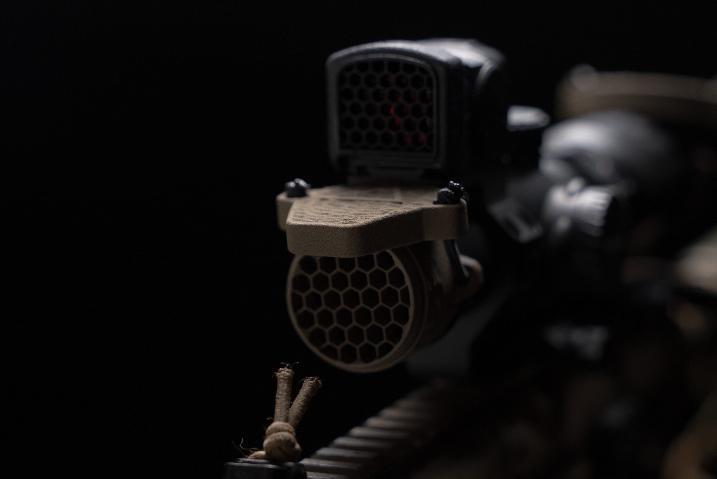 ScopeCap Pro 34mm LPVO scope cap with kill flash honeycomb attached by shock cord in flat dark earth color
