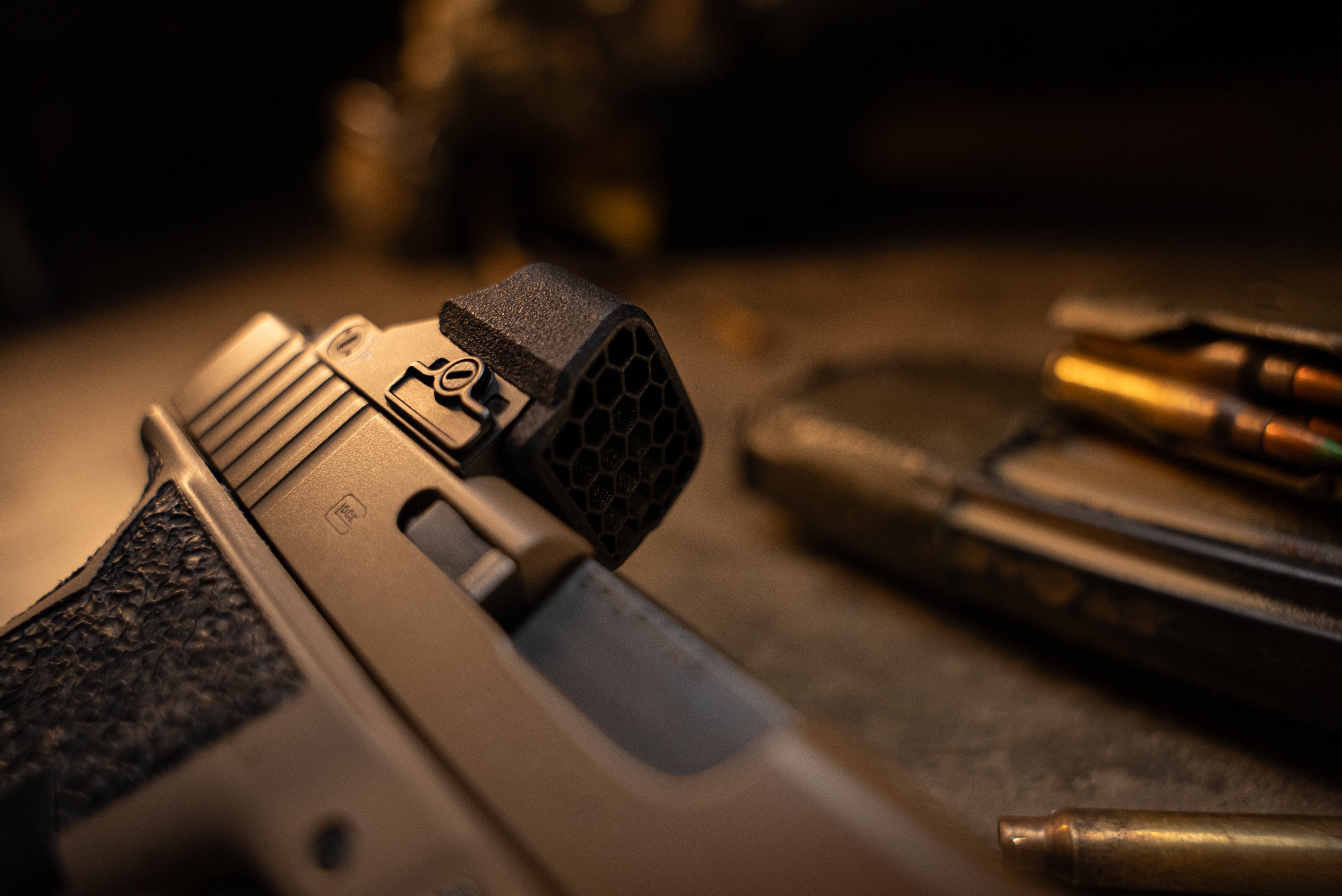 One Hundred concepts Hexcap on red dot sight mounted to a handgun